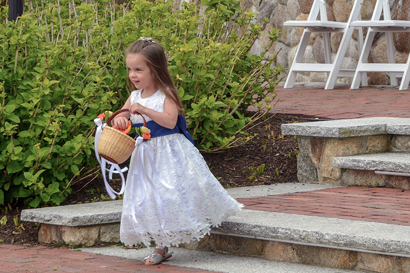 A flower girl making her entrance before the ceremony begins