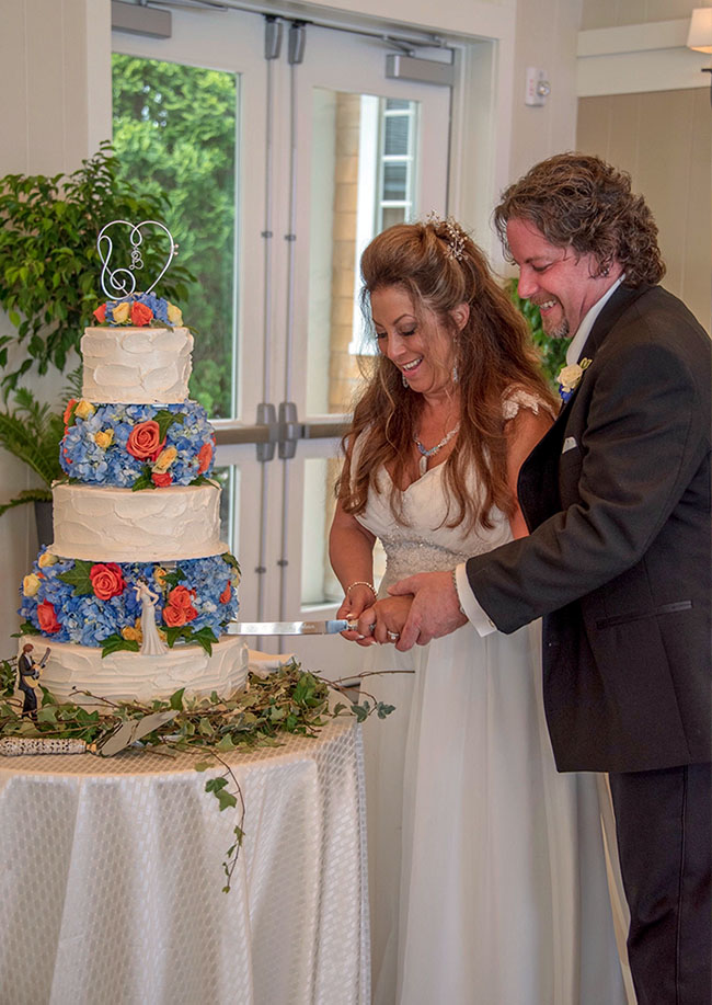 The bride and groom cutting their cake.