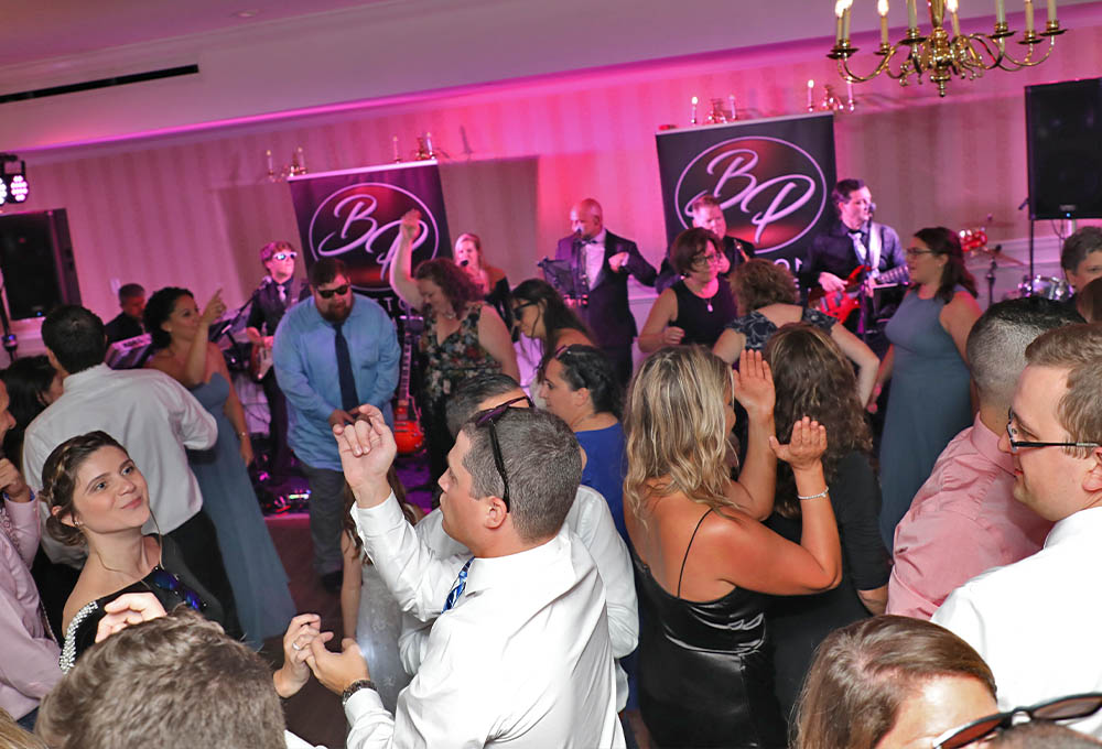 A photo of a packed dance floor at the wedding.