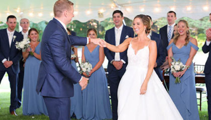Emily and Kevin smiling as they share their first dance as husband and wife.