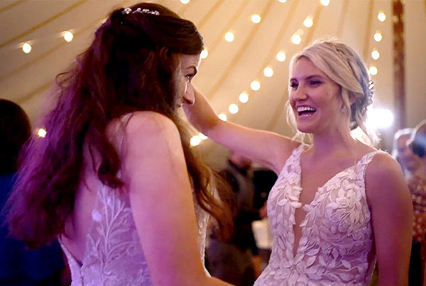 Two brides dance together at their wedding reception at the Connemara House Farm