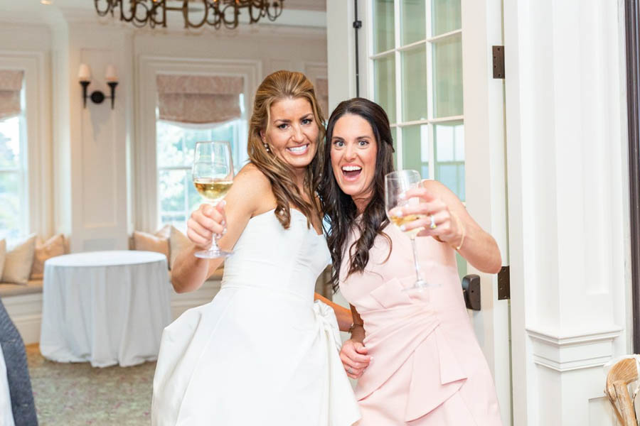 The bride having the time of her life with her bridesmaid