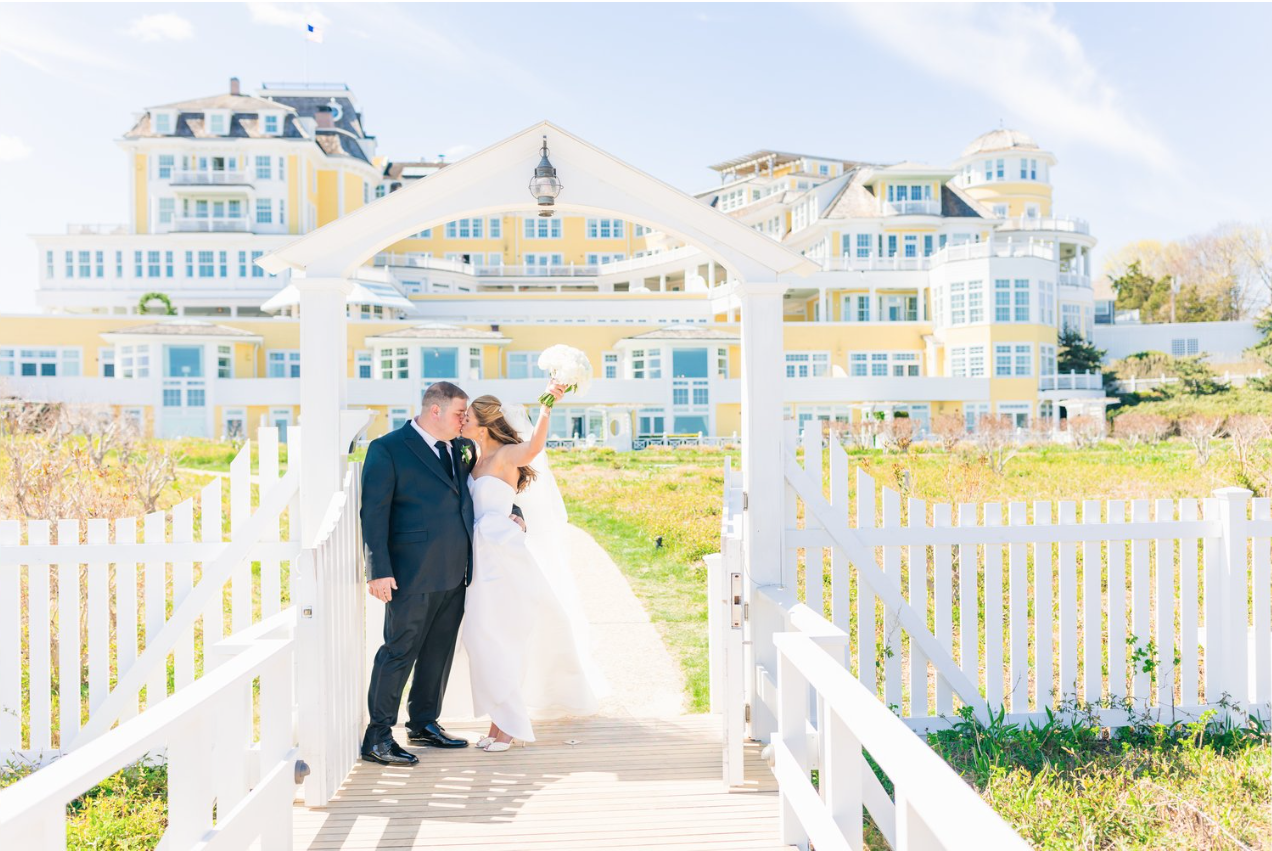 The Bride and groom posing outside the Ocean House in Watch Hill, RI