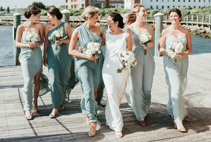 The bridesmaids walk towards the camera
