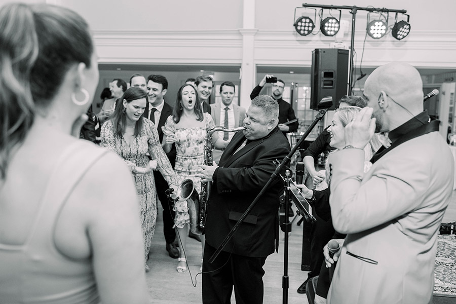 A saxophonist plays for the wedding crowd.