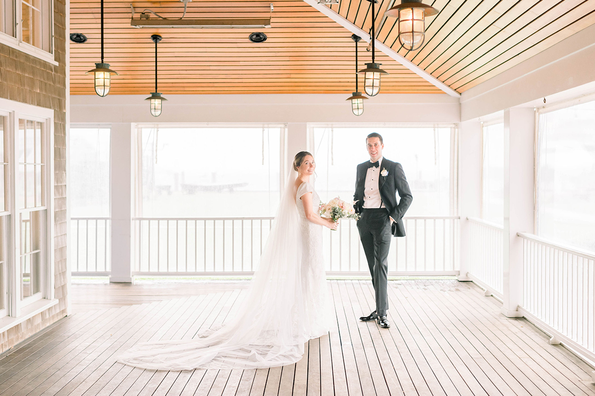 Bride and Groom posing for a photo at the nantucket yacht club