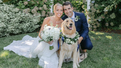 Erin and Adam pose with their dog for a wedding photo
