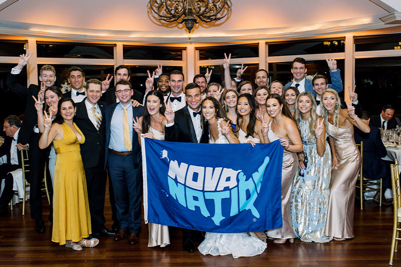 Villa Nova alumni share a photo with the bride and groom.