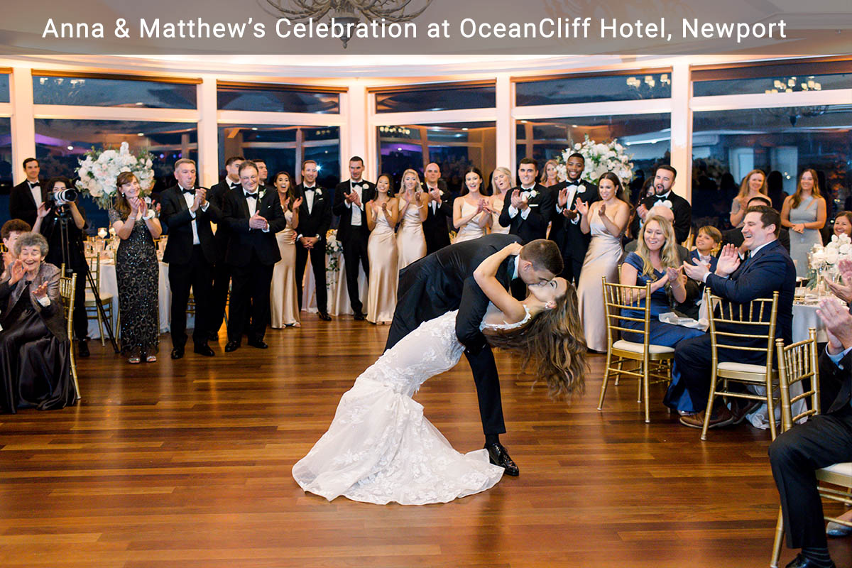 A groom dips his bride at the end of their first dance