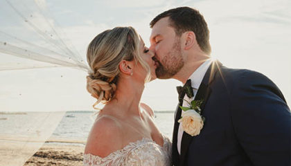 Jessica and Gavin steal a kiss on their wedding day.