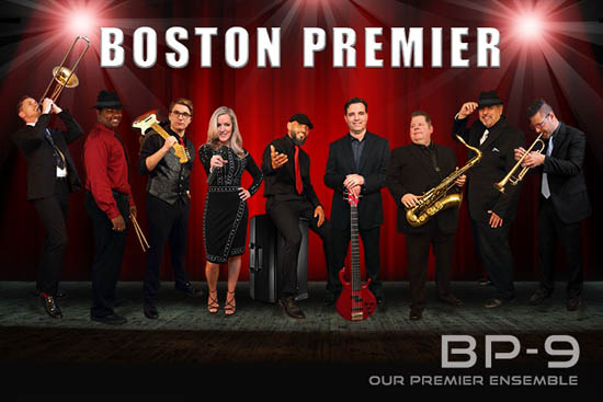 Boston Premier's 9-piece band posing on stage for a photo.