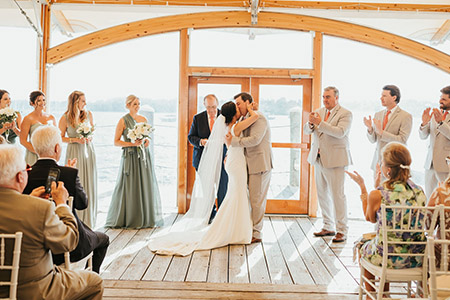 A bride and groom kiss at the conclusion of their ceremony held in Bristol, Rhode Island
