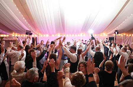 An active wedding crowd dancing to the music of the Boston Premier Band.