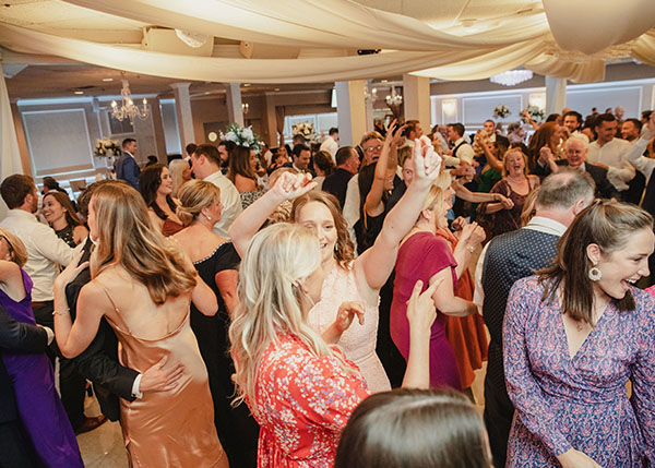 The dancefloor explodes in excitement as the band plays a great wedding dance hit.
