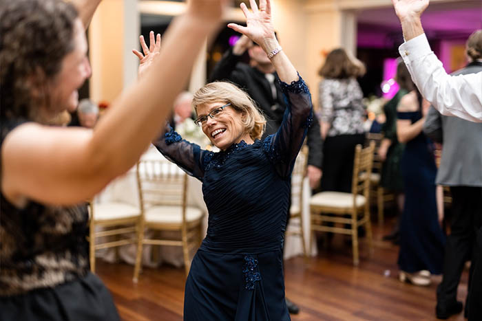 The mother of the bride dancing to the music of the Boston Premier band.