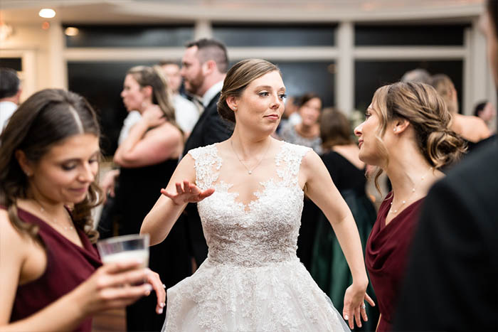 A bride and friends dancing to the music of the Boston Premier band.