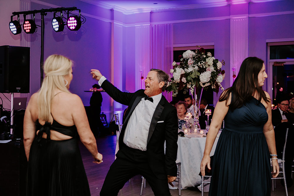 The father of the bride dancing wildly at the wedding reception.
