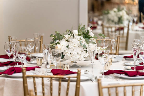 A wedding banquet table with a beautiful centerpice.